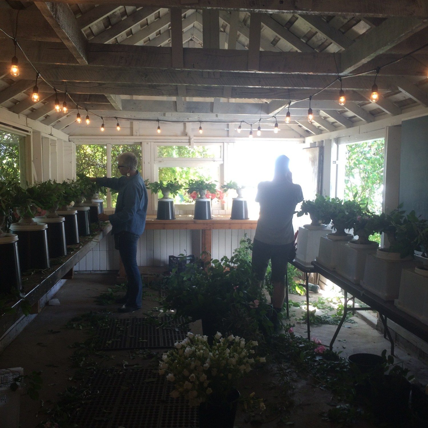 Erin Benzakein and Nina Foster arranging flowers for a wedding
